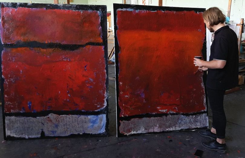 Artist Vladislav Chenchik works on his paiting
